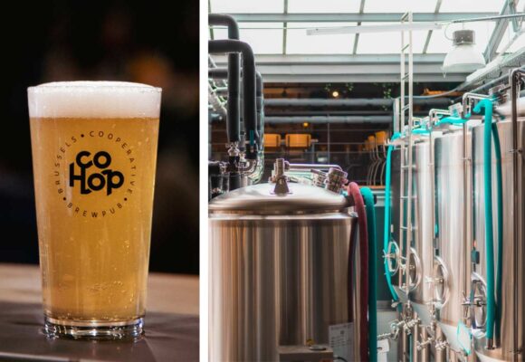 a freshly poured beer set on a table next to the brewhouse tanks